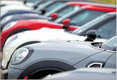  ?? AP ?? American spending on such things as new vehicles like these Cooper Countryman models at a dealership in Colorado, revved up in April.