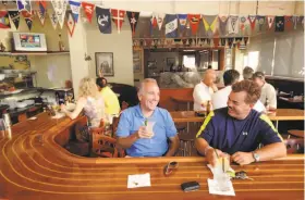  ?? Photos by Noah Berger / Special to The Chronicle 2009 ?? The Walnut Creek Yacht Club bar is decorated with nautical flags and a shark.