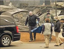  ?? Carolyn Cole Los Angeles Times ?? A BODY is recovered from the mobile home park during the search for victims of the Camp fire in November. Most of the people who died in the blaze were seniors.