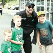  ??  ?? Glenn Maxwell takes a snap with young fans, from left, Ollie Lacunes, Johnty Lacunes and Archie Price.