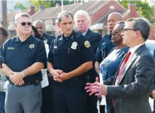  ?? STAFF PHOTO BY ANGELA LEWIS FOSTER ?? District Attorney General Neal Pinkston, right, speaks Monday near the intersecti­on of 4th Avenue and 25th Street during a press conference to announce the filing of a petition to abate certain gangs as a nuisance and to create an East Lake Safety Zone.