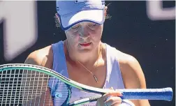 ?? ANDY BROWNBILL/ASSOCIATED PRESS ?? Ash Barty wipes sweat from her racket during her quarterfin­al match with Karolina Muchova on Tuesday. Barty was trying to become the first Australian woman to win the Aussie Open since 1978.