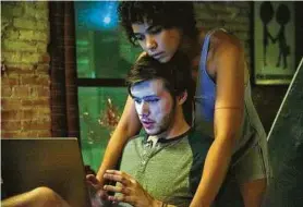  ?? Lionsgate ?? Nick Robinson portrays Ross Ulbricht and Alexandra Shipp plays his girlfriend, Julia Vie, in “Silk Road.”