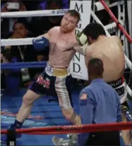  ?? ISAAC BREKKEN — THE ASSOCIATED PRESS ?? Canelo Alvarez, of Mexico, left, punches Julio Cesar Chavez Jr., of Mexico, during their catch weight boxing match Saturday, May 6, 2017 in Las Vegas.