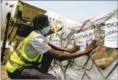  ?? DIOMANDE BLE BLONDE AP ?? A shipment of COVID-19 vaccines distribute­d by the COVAX initiative arrives in Ivory Coast in February.