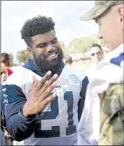  ?? AP/MICHAEL OWEN BAKER ?? Dallas running back Ezekiel Elliott talks to a fan after practice at training camp in Oxnard, Calif., on Friday. The NFL suspended him for the first six games of the season for domestic abuse.
