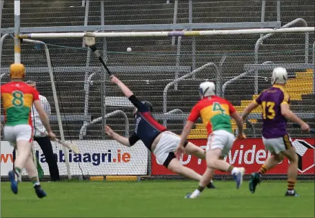  ??  ?? Cathal Dunbar (13) admires his handiwork after planting his second goal past Carlow netminder Damien Jordan.