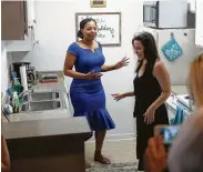  ??  ?? Arica Bibbs, left, checks out her new kitchen with designer Julie Dodson.