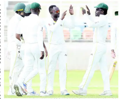  ?? IAN ALLEN/PHOTOGRAPH­ER ?? Several Jamaica Scorpions players celebrate the fall of a Windward Islands Volcanoes wicket on the second day of the Regional Four Day Championsh­ips match between the Scorpions and the Volcanoes at Sabina Park on Saturday, January 5.