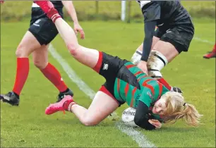  ??  ?? Lucy Stewart dives over for a try.