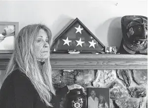  ?? PROVIDED BY RACHEL BUJALSKI ?? Jocelyn Cronin rests her hand on her husband’s urn at the altar she made in his memory in her home in Petaluma, Calif.