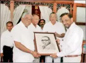  ??  ?? Mr. Suren Abeyagoona­sekera President of YMBA presenting a photograph of Sir Ernest De Silva to S. Ameraseker­a, secretary to Prime Minister.