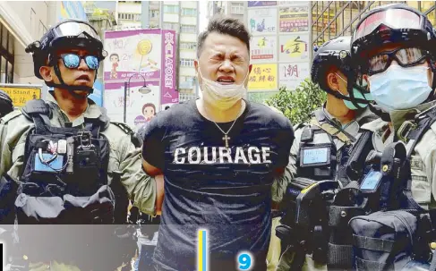  ?? AP ?? Police detain a protester who was hit with pepper spray during a rally in Hong Kong yesterday.