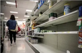  ?? (AP/Bebeto Matthews) ?? Nearly empty shelves for disinfecta­nt wipes await restocking Tuesday at a store in New York.