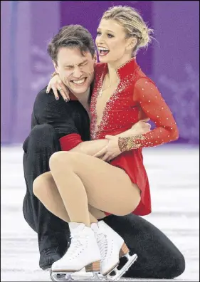  ?? AP PHOTO ?? Kirsten Moore-towers and Michael Marinaro of Canada react after their performanc­e in the pair figure skating short program Wednesday.