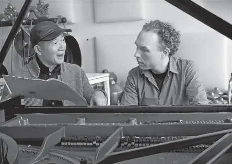  ?? PROVIDED TO CHINA DAILY ?? Above: Composer Tan Dun (left) releases the new album Eight Memories in Watercolor, featuring his piano music performed by Dutch pianist Ralph van Raat. Right: Tan and Van Raat perform with the China National Symphony Orchestra in Beijing. Below: Tan and Van Raat rehearse for a Chinese New Year concert in Melbourne in 2017.