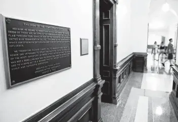  ?? Tom Reel / Staff photograph­er ?? A plaque stating the Children of the Confederac­y Creed is positioned in a narrow hallway just outside the main concourse of the Capitol’s rotunda.