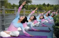  ?? HAO QUNYING / FOR CHINA DAILY ?? Young people stretch at a park in Handan, Hebei province, ahead of Internatio­nal Yoga Day on June 21.