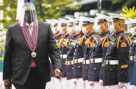  ?? Rolex dela Pena / Associated Press ?? U.S. Defense Secretary Lloyd Austin views a military honor guard in Quezon City. Austin held talks with Philippine officials to boost defense ties.