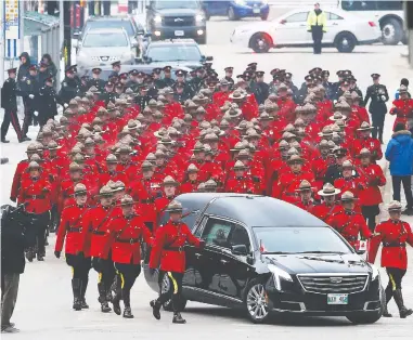  ?? JOHN WOODS / THE CANADIAN PRESS ?? The regimental funeral procession for RCMP Const. Allan Poapst in downtown Winnipeg on Friday included
hundreds of law enforcemen­t officers, military personnel and other first responders from across Canada.