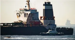  ??  ?? Under guard: The Grace 1 tanker after yesterday’s operation off Gibraltar and, below, a Royal Marine boat patrols nearby