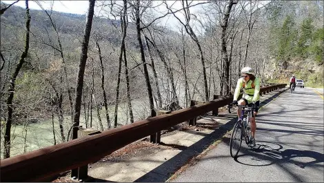  ?? NWA Democrat-Gazette/FLIP PUTTHOFF ?? Karen Mowry takes in a view of the Mulberry River from the Mulberry River Road Scenic Byway on March 26. The route runs parallel to the river along Arkansas 215.