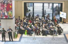  ?? JIM WELLS ?? Observers gathered in the overflow area in the atrium at city hall on Monday to watch speakers both for and against the proposed blanket rezoning policy address members of council.