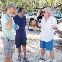  ??  ?? Toyota Jamaica’s managing director, Tom Connor (right), engaged in conversati­on with Patrick March (left) and John Orelue.