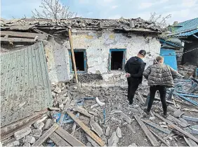  ?? VORONEZH NEWS TELEGRAM CHANNEL VIA THE ASSOCIATED PRESS ?? People survey a house damaged in a Ukrainian drone attack in Voronezh, Russia. Three Ukrainian balloons and one drone were downed over the region.