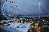  ?? STEPHEN M. DOWELL /ORLANDO SENTINEL VIA AP ?? ICON Park attraction­s, The Wheel, left, Orlando SlingShot, middle, and Orlando FreeFall, right, are shown in Orlando, Fla., on Thursday.