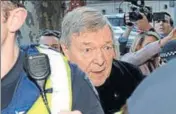  ?? AFP ?? Cardinal George Pell (centre) arrives under heavy police protection for a hearing at the Melbourne Magistrate­s Court on Wednesday.