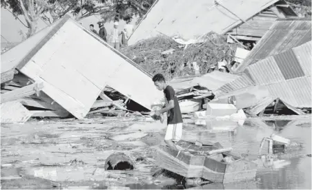  ??  ?? Officials said more than 380 were dead in Palu alone, and more were unaccounte­d for, in the wake of the deadly earthquake-triggered tsunami. The waves reached as high as six metres in at least one area, according to a survivor’s report.