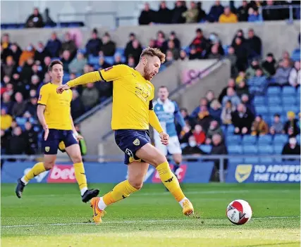  ?? Picture: Alex Burstow/Getty ?? Matty Taylor scores for Oxford against Bristol Rovers at the Kassam Stadium