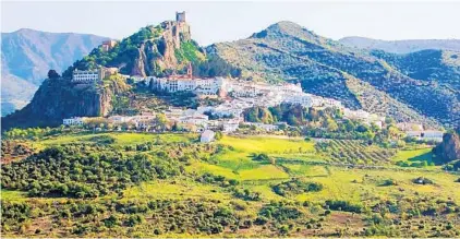 ?? RICK STEVES/RICK STEVES’ EUROPE PHOTOS ?? characteri­stically whitewashe­d Andalusian town with an evocative Moorish castle.