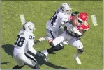  ?? CHARLIE RIEDEL - AP ?? Las Vegas Raiders safety Johnathan Abram (24) and safety Jeff Heath (38) break up a pass intended for Kansas City Chiefs wide receiver Tyreek Hill (10) during the first half Sunday in Kansas City.