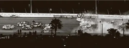  ?? Chris O'Meara / Associated Press ?? Cars crash during the last lap of Sunday night’s Daytona 500. Michael McDowell, left, in the No. 34 car, went on to claim his first career NASCAR Cup Series victory.