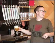  ?? NWA Democrat-Gazette/J.T. WAMPLER ?? Taptender Hannah Gilliam pulls a beer while talking to a customer Sunday at New Province Brewing Co. in Rogers. A report from earlier this year ranked Northwest Arkansas 180th out of the 200 best metropolit­an areas for small business.