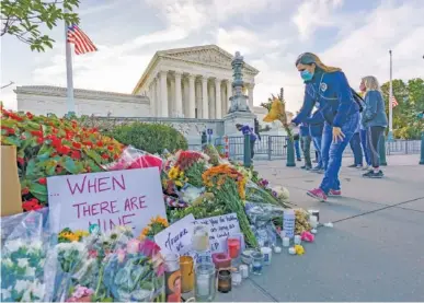  ?? AP PHOTO/J. SCOTT APPLEWHITE ?? People gather at the Supreme Court on the morning after the death of Justice Ruth Bader Ginsburg on Saturday in Washington.