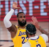  ?? Tribune News Service ?? Los Angeles Lakers’ Lebron James (23) high-fives Anthony Davis during the second half of Game 1 of basketball’s NBA Finals Wednesday, in Lake Buena Vista, Fla.