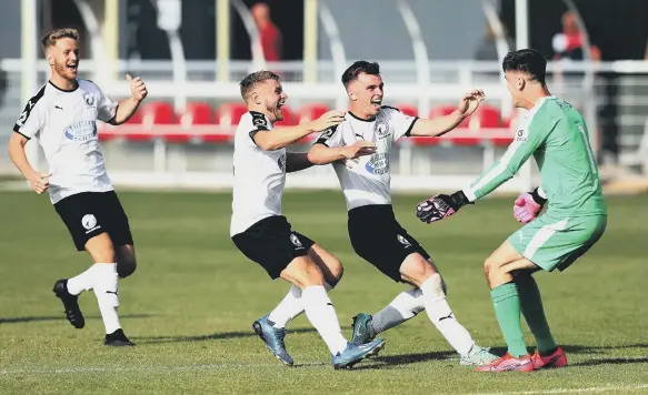  ??  ?? Gateshead players celebrate with their goalkeeper Bradley James after he saves the last penalty in the Vanarama National League North Play-Off match against Brackley Town.
