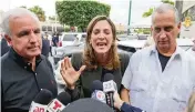  ?? AL DIAZ adiaz@miamiheral­d.com ?? U.S. Rep. María Elvira Salazar, center, flanked by fellow members of Congress Carlos Giménez, left, and Mario Díaz-Balart, right, in August at Versailles.