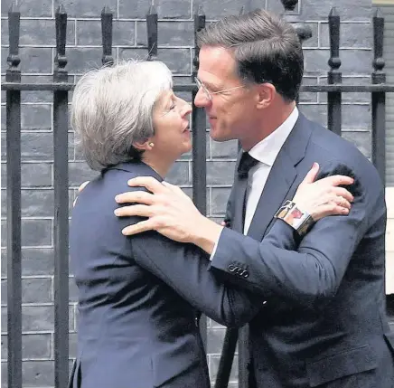  ??  ?? > Prime Minister Theresa May greets Prime Minister of the Netherland­s Mark Rutte outside Downing Street yesterday