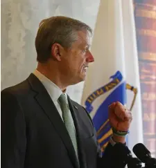  ?? Pool FIle ?? SINGED: Gov. Charlie Baker told reporters his ‘hair’s on fire’ when the Vaxfinder website crashed last month.