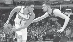  ?? DAVID BANKS/USA TODAY SPORTS ?? Bulls guard Tomas Satoransky (31) defends Phoenix Suns guard Devin Booker (1) during the first half at United Center.