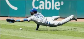  ?? TONY DEJAK/THE ASSOCIATED PRESS ?? After Toronto Blue Jays right fielder Jose Bautista slips and falls, a ball hit by the Indians’ Carlos Santana drops in for a triple during the eighth inning of a game last Thursday afternoon at Progressiv­e Field in Cleveland. The Indians won that...
