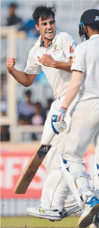  ??  ?? Australian bowler Pat Cummins (left) celebrates after he dismissed India's Lokesh Rahul (right) during the second day of the third Test cricket match between India and Australia.