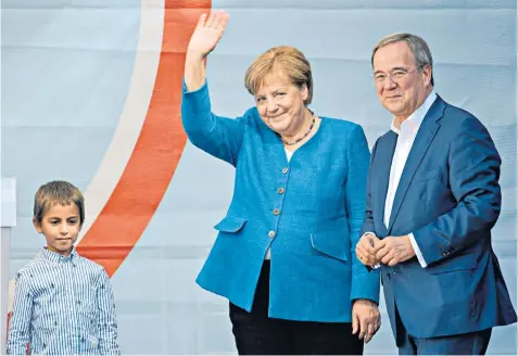  ?? ?? Parting shot: German Chancellor Angela Merkel acknowledg­es the crowd alongside Armin Laschet, who aims to succeed her, at a campaign rally in Aachen yesterday