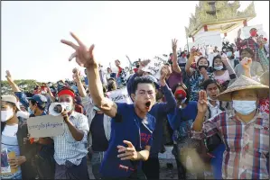  ?? (File Photo/AP) ?? Demonstrat­ors flash a three-fingered symbol of resistance against the military coup and shout slogans calling for the release of detained Myanmar State Counselor Aung San Suu Kyi on Feb. 10 during a protest in Mandalay, Myanmar.