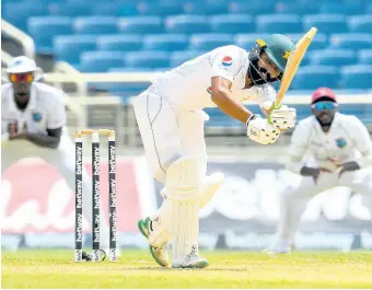  ?? CRICKET WEST INDIES PHOTO ?? Pakistan batsman Fawad Alam (centre) plays a shot during action on the third day of the second Test against the West Indies at Sabina Park on Sunday, August 22, 2021. Both teams will renew rivalry when the West Indies tour Pakistan next month.