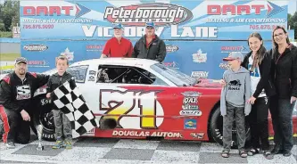  ?? JIM CLARKE CLARKE MOTORSPORT­S COMMUNICAT­ION ?? Family members and friends help Dan McHattie celebrate one of the main event wins that led to the 2018 Late Model track championsh­ip at Peterborou­gh Speedway.